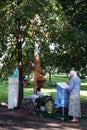 Grandma praying in the street at the shrine