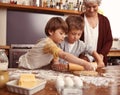 Grandma, smile and children baking in kitchen, learning or happy boys bonding together in family home. Grandmother, kids Royalty Free Stock Photo
