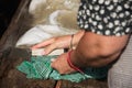 Grandma washes by hand, an old fashioned washing trough filled with water