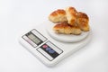 Grandmas bun rolls on the digital kitchen scale Royalty Free Stock Photo