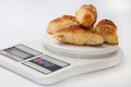 Grandmas bun rolls on the digital kitchen scale Royalty Free Stock Photo