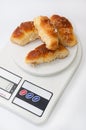 Grandmas bun rolls on the digital kitchen scale Royalty Free Stock Photo