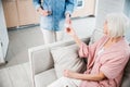 Young woman giving pills to old lady Royalty Free Stock Photo
