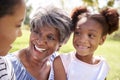 Grandmother With Adult Daughter And Granddaughter Relaxing In Park Royalty Free Stock Photo