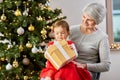 grandmother and baby girl with christmas gift