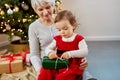 grandmother and baby girl with christmas gift