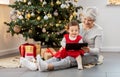 grandmother and baby girl with christmas gifts