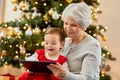 grandmother and baby girl with christmas gifts