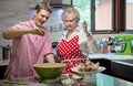 Grandmother baking cupcakes with her grandson Royalty Free Stock Photo