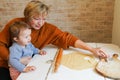 Grandmother baking tasty sweet cookies together with her grandda Royalty Free Stock Photo
