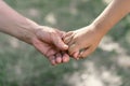 Grandmother and child hold hands.