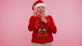 Grandmother in Christmas sweater make gesture raises finger came up with creative plan good idea