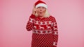Grandmother in Christmas sweater make gesture raises finger came up with creative plan good idea