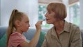 Grandmother and cute girl playing with makeup. Family having fun indoors Royalty Free Stock Photo