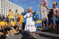 Grandmother dances with swedish football fans Royalty Free Stock Photo