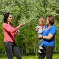 Grandmother, daughter and granddaughter blow bubbles