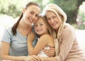 Grandmother With Daughter and Granddaughter Laughing Together On Sofa Royalty Free Stock Photo