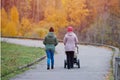 Grandmother and daughter walking in autumn park