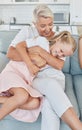 Grandmother, family and child at home with a senior woman having fun, bonding and laughing for tickle and playing on Royalty Free Stock Photo