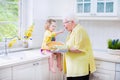 Grandmother and funny girl baking pie in white kitchen Royalty Free Stock Photo