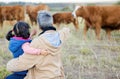 Grandmother, girl back and cows on a walk with kid and senior woman in the countryside. Outdoor field, grass and elderly