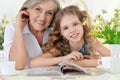 Grandmother with girl reading magazine Royalty Free Stock Photo