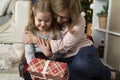 Close up of grandmother giving her granddaughter a Christmas gift Royalty Free Stock Photo