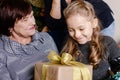 Grandmother giving her granddaughter Christmas gift Royalty Free Stock Photo