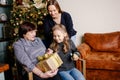 Grandmother giving her granddaughter Christmas gift Royalty Free Stock Photo