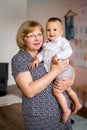 A grandmother with glasses hugs a small grandson. Royalty Free Stock Photo