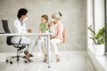 Grandmother with grandaughter at black female doctor Royalty Free Stock Photo