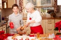 Grandmother with grandchild in kitchen, christmas.