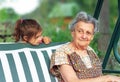 Grandmother with grandchild - senior woman taking and smiling with her granddaughter outdoor