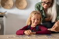Grandmother and grandchild solving jigsaw puzzle Royalty Free Stock Photo