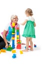 Grandmother with grandchildren playing with blocks