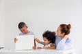 Grandmother and grandchildren playing cheerfully in living room, Children and grandparents drawing together pictures, Boy showing Royalty Free Stock Photo