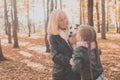 Grandmother with granddaughter in autumn park, girl hugging grandmother and her jack russell terrier dog. Generations Royalty Free Stock Photo