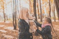 Grandmother with granddaughter in autumn park, girl hugging grandmother and her jack russell terrier dog. Generations Royalty Free Stock Photo