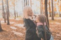 Grandmother with granddaughter in autumn park, girl hugging grandmother and her jack russell terrier dog. Generations Royalty Free Stock Photo