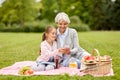 Grandmother and granddaughter with cell at park Royalty Free Stock Photo