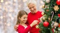 Grandmother and granddaughter at christmas tree Royalty Free Stock Photo