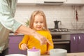 Grandmother and granddaughter cook in kitchen in middle, family pastime