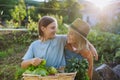 Grandmother with granddaughter with crate full of vegetables. Concept of importance of grandparents - grandchild Royalty Free Stock Photo