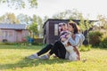 Grandmother with granddaughter and dog playing on the sunbathing lawn Royalty Free Stock Photo