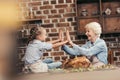 grandmother and granddaughter giving double high five on thanksgiving after successful Royalty Free Stock Photo