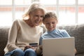 Grandmother and granddaughter have fun shopping online together Royalty Free Stock Photo