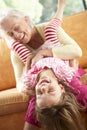 Grandmother And Granddaughter Having Fun On Sofa Royalty Free Stock Photo