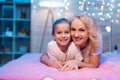 Grandmother and granddaughter are hugging at night at home. Royalty Free Stock Photo