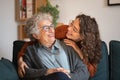 Grandmother and granddaughter laughing and embracing at home Royalty Free Stock Photo