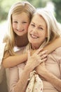 Grandmother With Granddaughter Laughing Together On Sofa Royalty Free Stock Photo